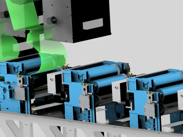 Blue rollers and green web material in an industrial converting system