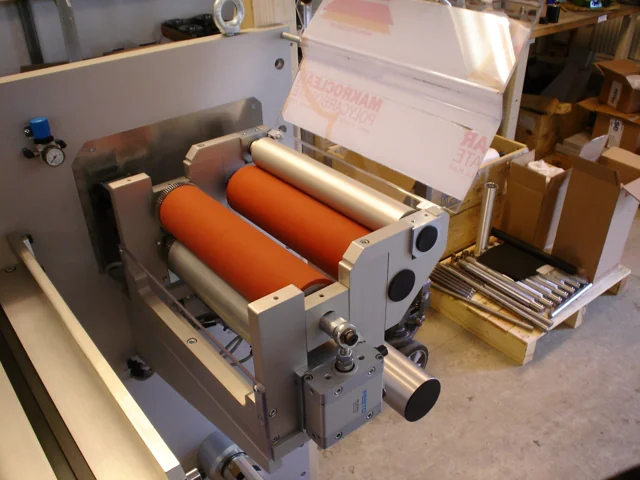 Close-up of a roller assembly with orange rollers