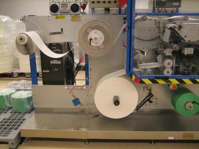 Material reels and web path inside an industrial converting machine